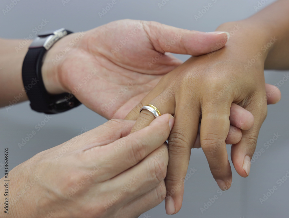 Close up of Holding Hands with wedding rings on the ceremony image Close up of Holding Hands with wedding rings on the ceremony image