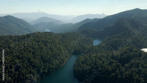 Panoramic view of huerquehue national park with the lagoons chico, verde, toro and tinquilco between araucaria forests (Araucaria araucana) and the volcano villarrica in the background - aerial photo