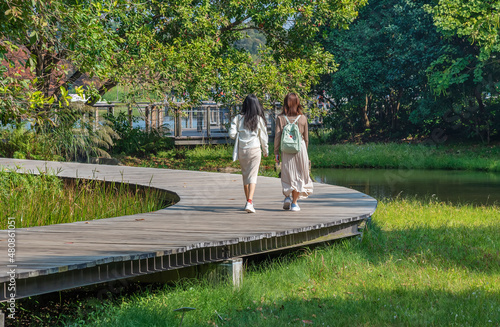 Tourist walking on wooden trail in Hong Kong wetland park photo