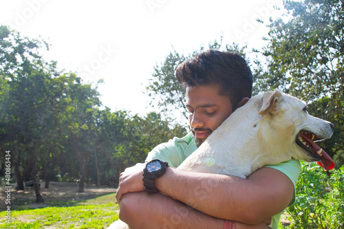 Photography Young adult man hugging his dog