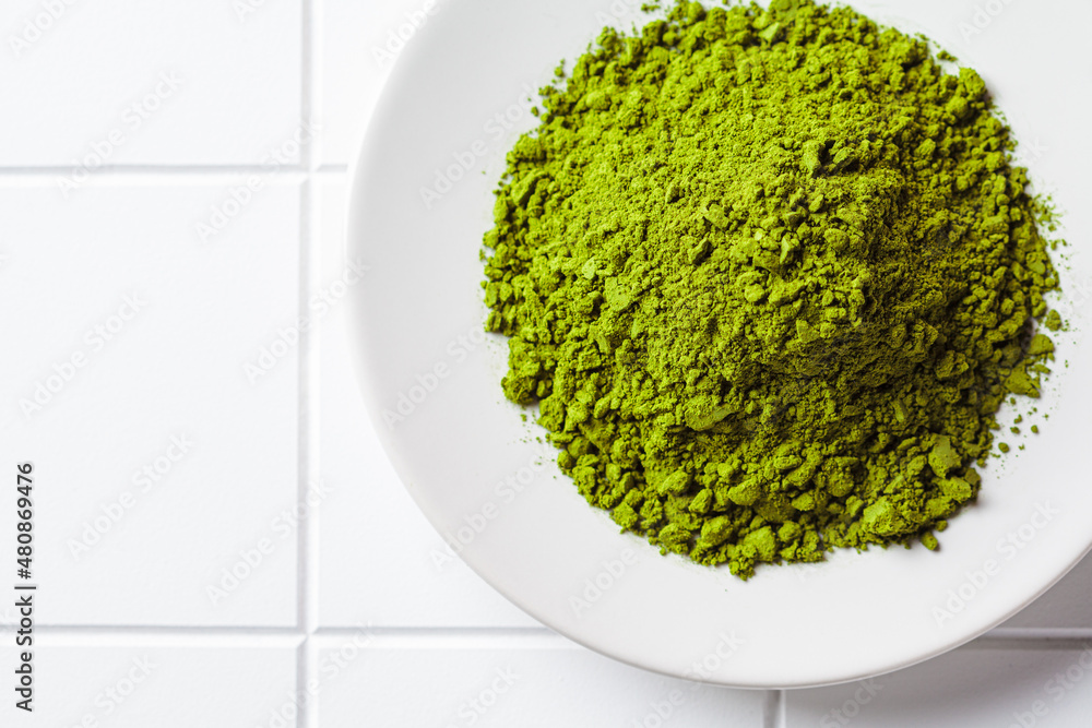 Matcha green tea powder on a white plate. Matcha green tea powder on a white plate.