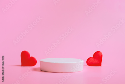Valentine's day background with podiums for products or cosmetics with hearts on a pink background. closeup.