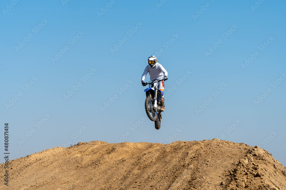 jumping on a motorcycle. motocross. motorcycle racing. bikers on the track jumping on a motorcycle. motocross. motorcycle racing. bikers on the track