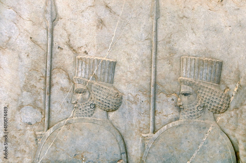 Photos Ancient wall with bas-relief with assyrian warriors with with spears and shields