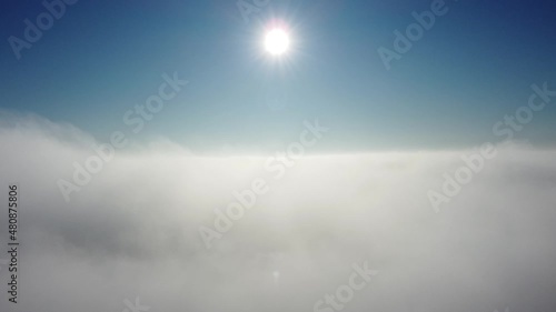 Sun is rising above the endless sea of clouds until the horizon. Amazing nature landscape, 4K drone in sky