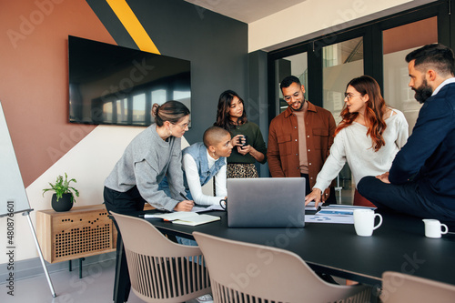 Diverse businesspeople discussing some reports in a boardroom photo