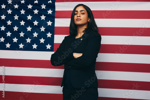 Congresswoman standing against an American flag photo