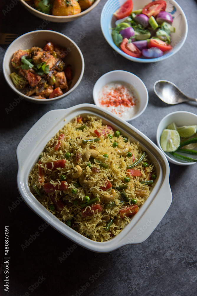 Homemade Indian lunch item pulao or vegetable fried rice or biryani served in a bowl. Top view. Homemade Indian lunch item pulao or vegetable fried rice or biryani served in a bowl. Top view.