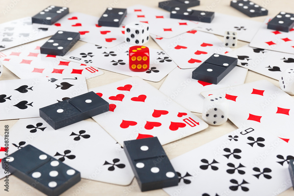 Dominoes, playing cards and dice for board games on table close up. Dominoes, playing cards and dice for board games on table close up.
