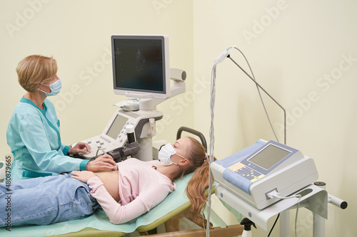 Serious female person looking at her doctor