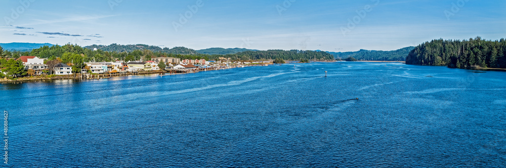 Panorama of the Siuslaw River flowing by the historic Old Town section of Florence, Oregon, USA