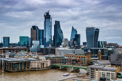 London city scape with cloudy sky and the Thames river.