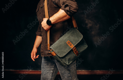 fashion, style and people concept - close up of hipster man with stylish shoulder bag