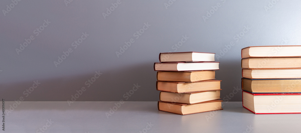 a pile of books on shelf ,concept of knowledge or learning , world book day . a pile of books on shelf ,concept of knowledge or learning , world book day .