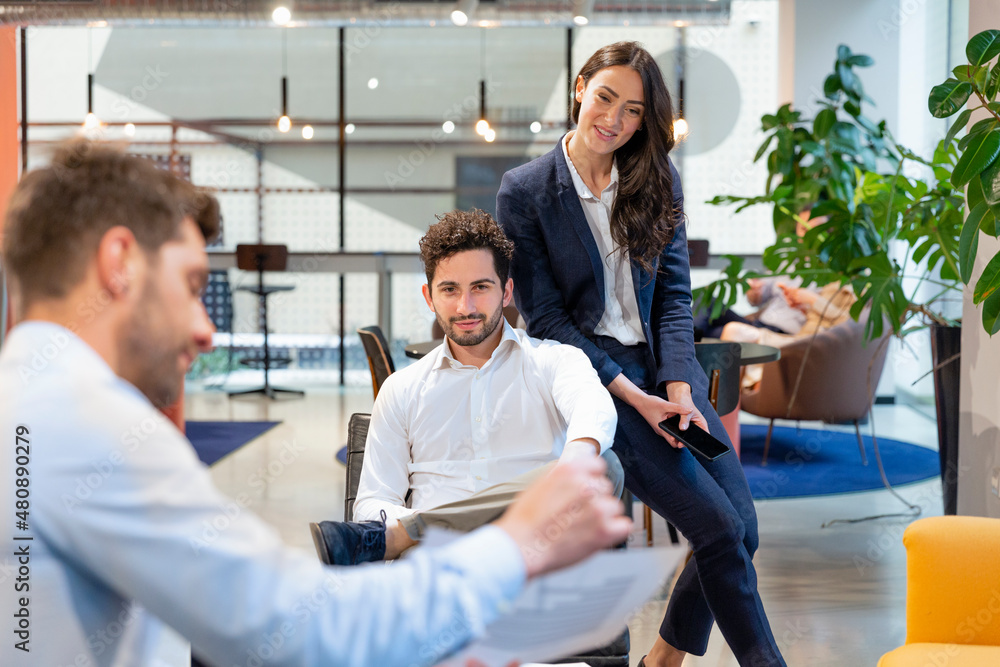 Businessman discussing with colleague at office Businessman discussing with colleague at office