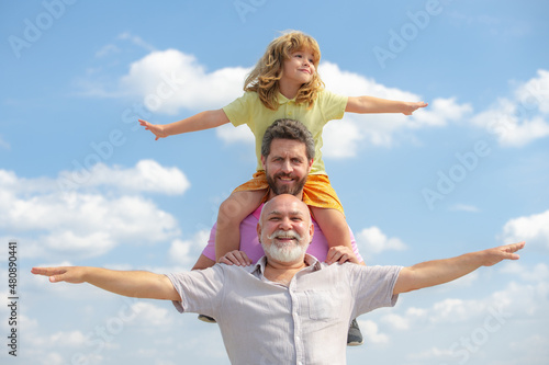 Portrait of parent grandfather, son and grandson raising hands or open arms flying. Parenting parenthood concept.