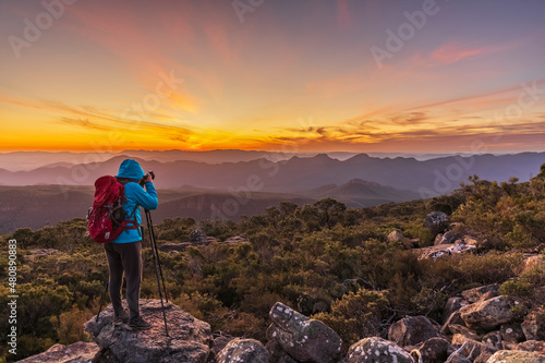 Australia, Victoria, Female tourist taking pictures from Mount William at sunset photo