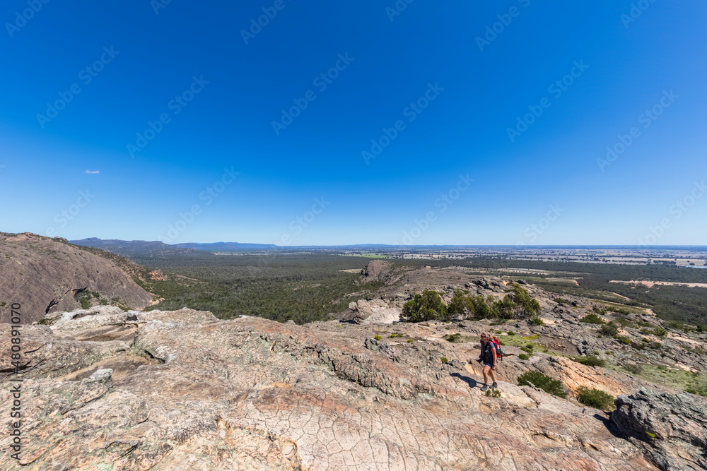 Australia, Victoria, Clear sky over female hiker ascending Hollow Mountain in Grampians National Park Australia, Victoria, Clear sky over female hiker ascending Hollow Mountain in Grampians National Park