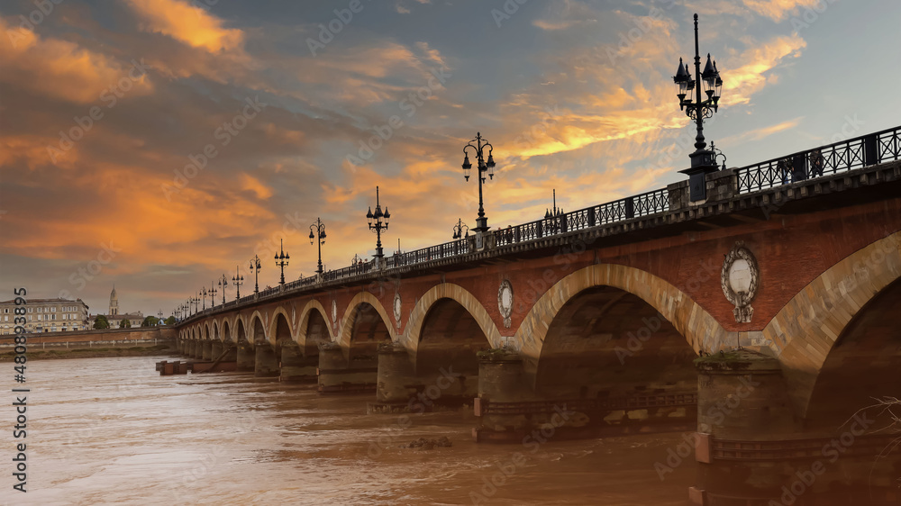 The sunset sky scene of the Pont de pierre at sunlight in the famous winery region Bordeaux, France