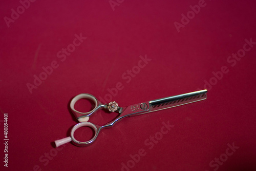 barber's metal scissors lie on the background