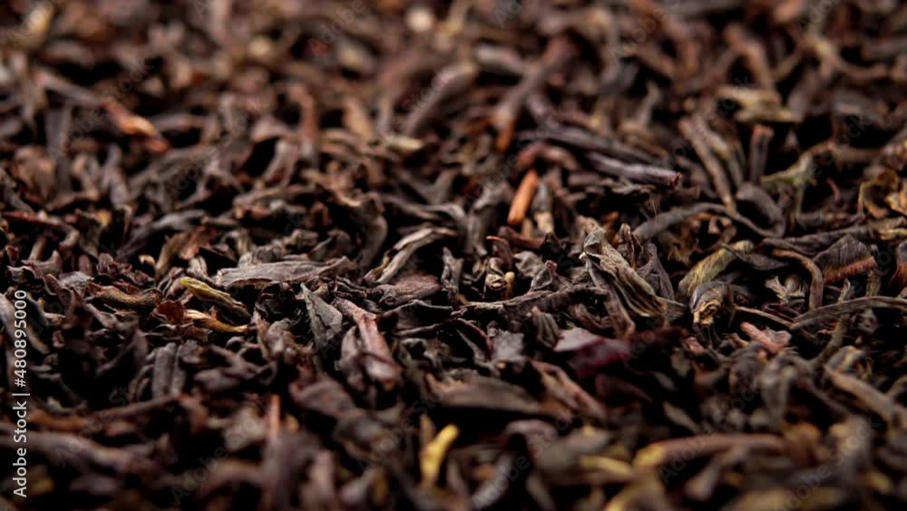 Black dried tea leaf. Falling dry leaves in slow motion. Macro. Rotation Black dried tea leaf. Falling dry leaves in slow motion. Macro. Rotation