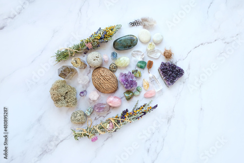 Gemstones, floral bundles for cleansing, nature magic things on marble table. healing minerals for Esoteric Witchcraft Ritual. wiccan magic, life balance concept. energy reiki therapy. top view