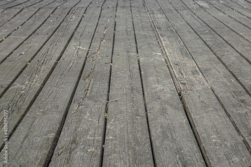 abstract background of an old wooden flooring on a walkway in a park close up