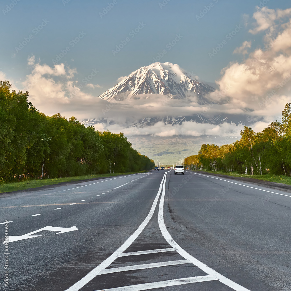 Naklejka premium The road against the background of the volcano. Travelling by car. Kamchatka Peninsula, Russia. Travel and tourism in the natural park