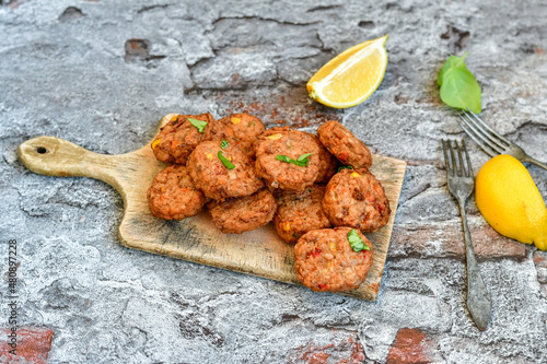 Home made  oven baked  mini meatballs  from  chicken and vegetable on  wooden background