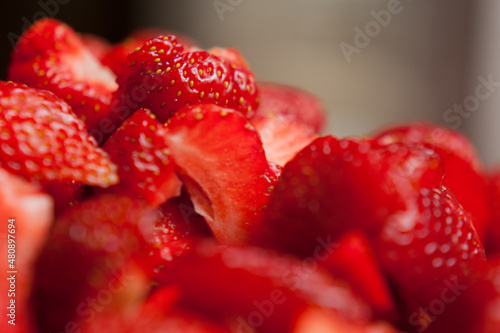 Photo of slices of strawberries with a blurred background.