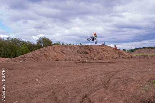 Belarus, Minsk / BLR - May 18nd 2015 : Competition of children on a motorcycle. Jumping on a motorcycle in the air.