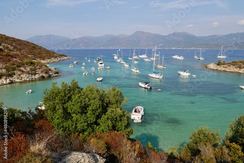 Luxury yachts in turquoise water at Fornali beach in Desert des Agriates. Corsica, France.