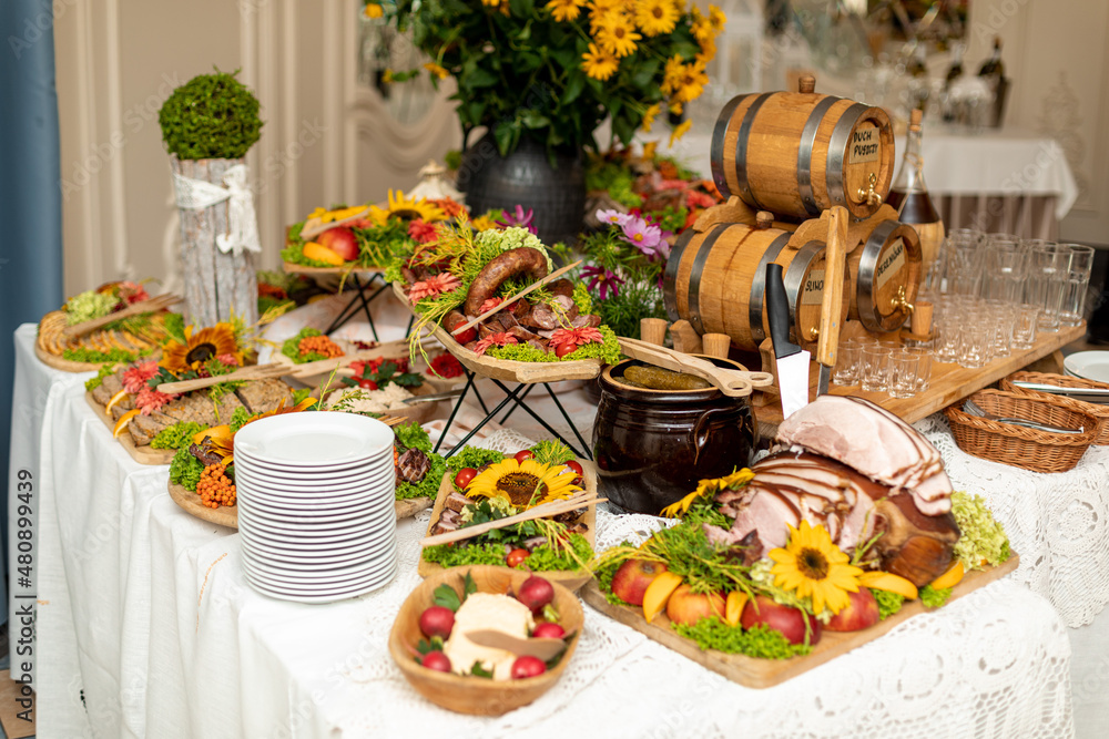  Beautifully served buffet with cold appetizers of national cuisine in restaurant hall for festive event. Recreation and entertainment. Tourism and travel .