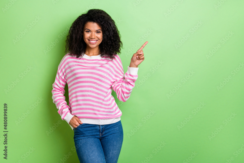 Portrait of attractive cheerful girl showing copy blank space ad avdert solution isolated over bright green color background Portrait of attractive cheerful girl showing copy blank space ad avdert solution isolated over bright green color background