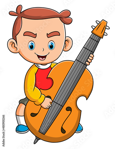 The happy boy playing and holding the big cello