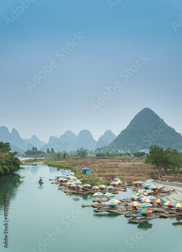 Looking out over the Li River in Guilin China over Boats with the Karst Mountains in the Distance