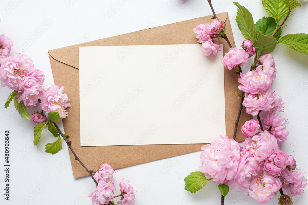 card invitation in envelope with pink spring flowers. sakura. almond flowers