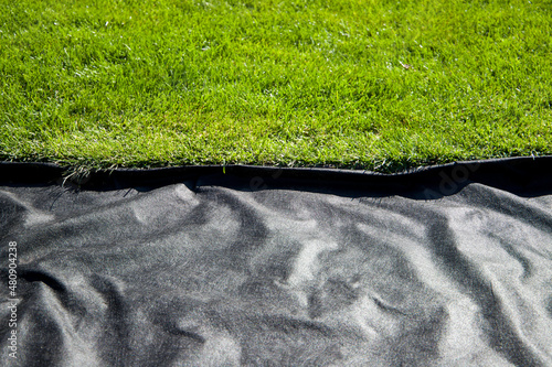 
Geotextile black and green lawn. Laying geotextiles. photo