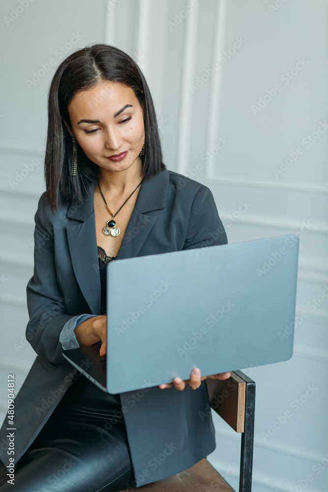 young Asian girl business style clothes, with a laptop young Asian girl business style clothes, with a laptop