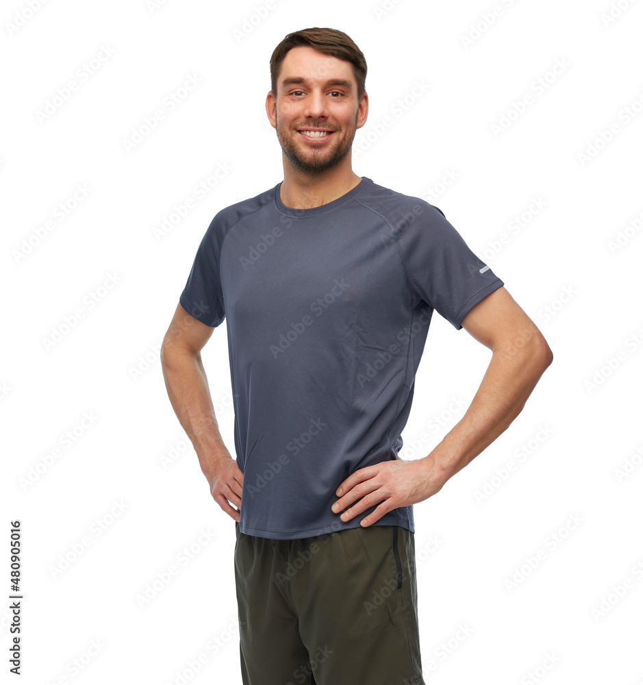 Obraz premium fitness, sport and healthy lifestyle concept - smiling man in sports clothes over white background