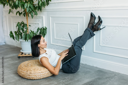 young Asian girl business style clothes, with a laptop