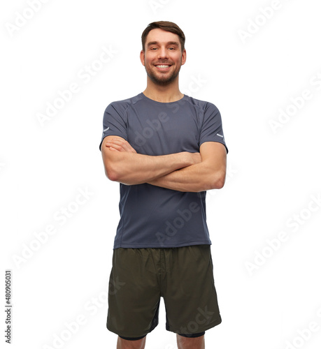 fitness, sport and healthy lifestyle concept - smiling man in sports clothes over white background