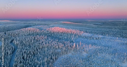 Aerial view of hills and forests of Lapland, colorful arctic sunrise - pull back, drone shot photo