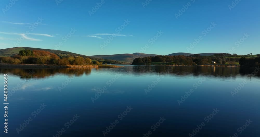 Blessington Lakes, Wicklow, Ireland. January 2022 Drone pushes east while gradually ascending above the Poulaphouca reservoir with Carrig and Lackan in the distance. Blessington Lakes, Wicklow, Ireland. January 2022 Drone pushes east while gradually ascending above the Poulaphouca reservoir with Carrig and Lackan in the distance.