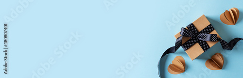 Photography Fathers day concept with gift and craft sustainble paper hearts on blue backgrou
