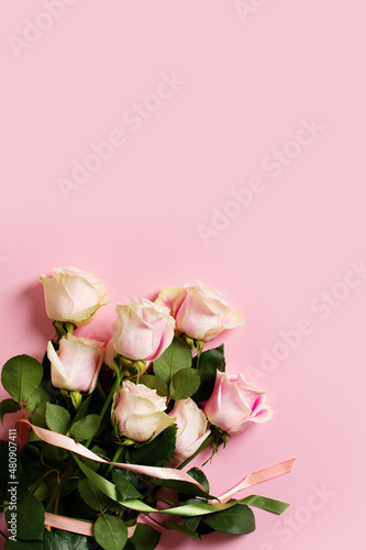 Flat lay with roses on pink background, valentines day and mothers day concept