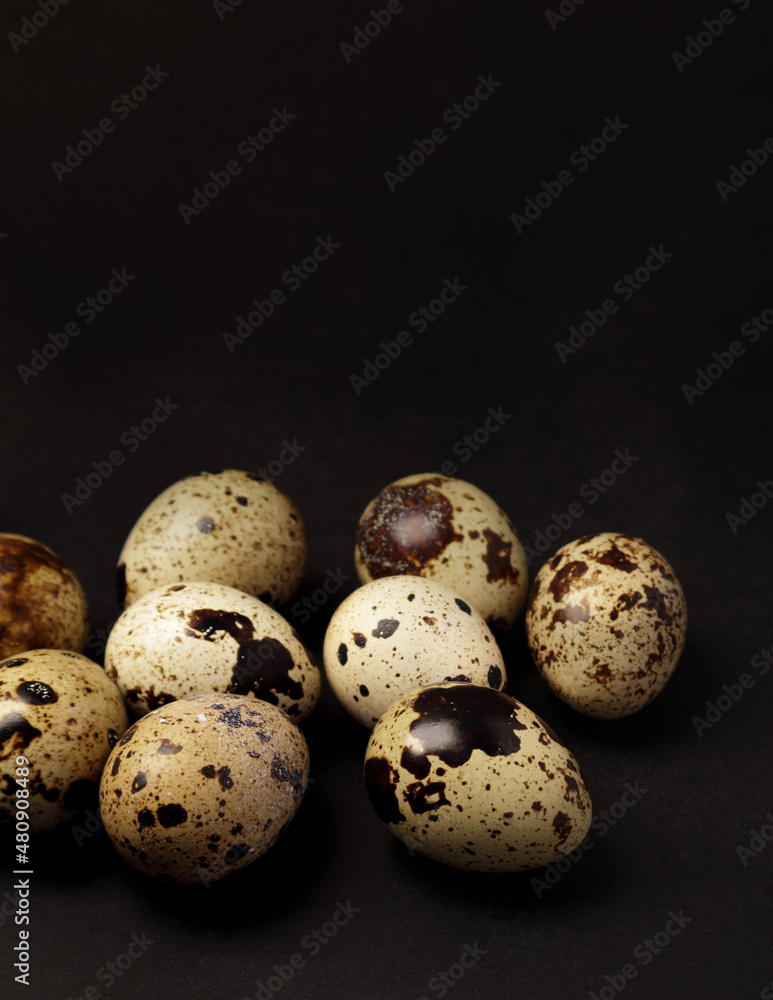 Quail eggs on black background. Healthy food concept. Selective focus