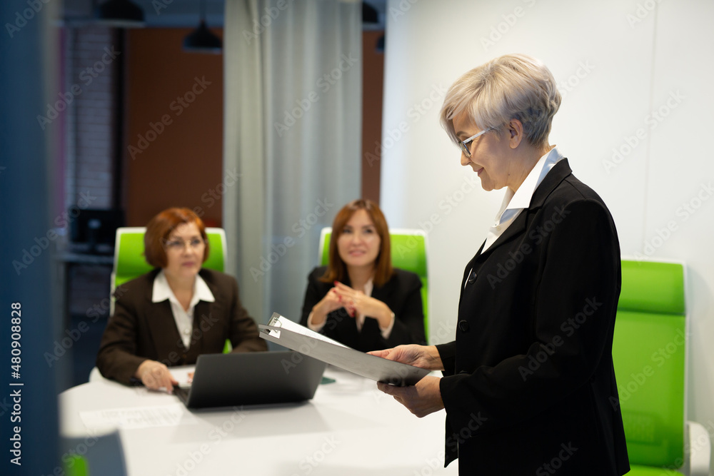 discussion at work of three adult women in the office discussion at work of three adult women in the office