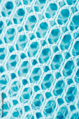 Blue mesh background. Mesh texture. Macro photo