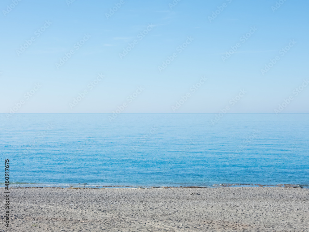Mediterranean Sea with a fragment of the beach on a calm sunny day Mediterranean Sea with a fragment of the beach on a calm sunny day